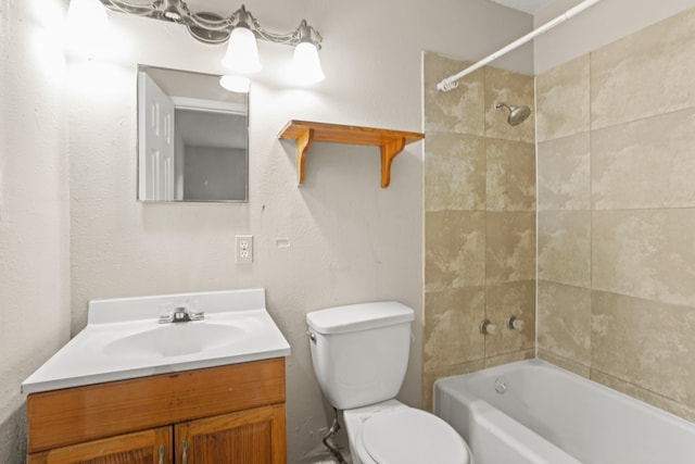 full bathroom featuring tiled shower / bath combo, toilet, and vanity