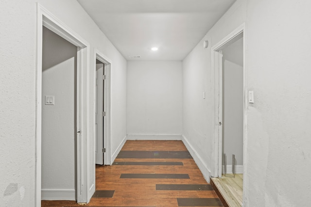 hall featuring dark wood-type flooring