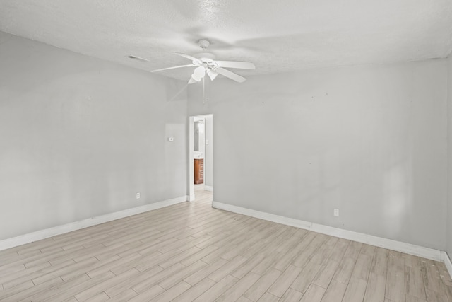 unfurnished room featuring light hardwood / wood-style floors, ceiling fan, and a textured ceiling