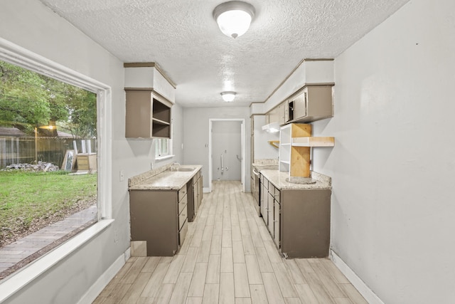 kitchen featuring light wood-type flooring and a textured ceiling