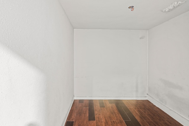 unfurnished room with dark hardwood / wood-style floors