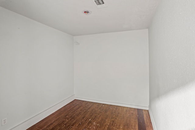 spare room featuring dark hardwood / wood-style floors