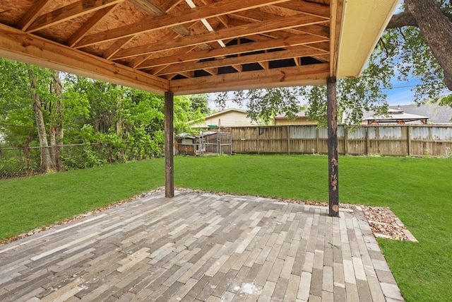 wooden deck with a patio and a yard