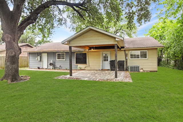 back of property with a patio, a yard, and central air condition unit