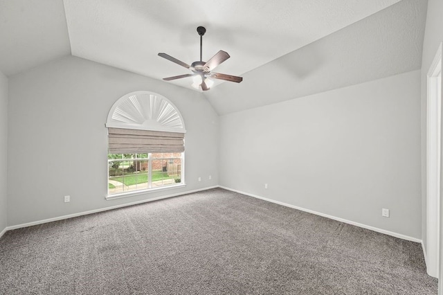 unfurnished room with vaulted ceiling, ceiling fan, and carpet flooring