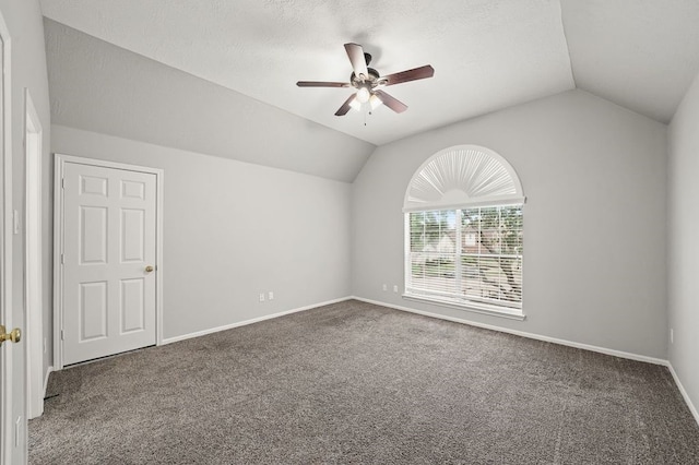 carpeted empty room with lofted ceiling and ceiling fan