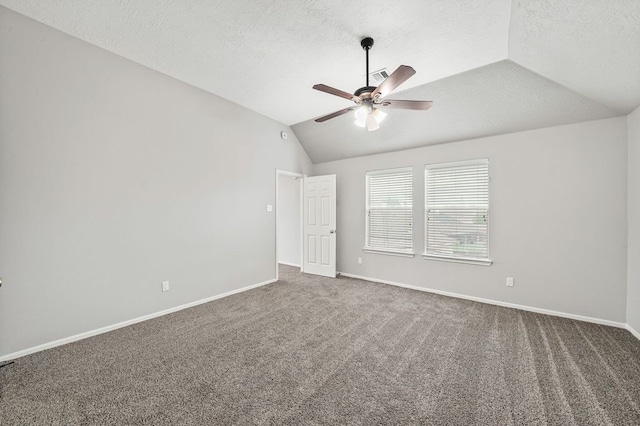 carpeted empty room with a textured ceiling, ceiling fan, and vaulted ceiling