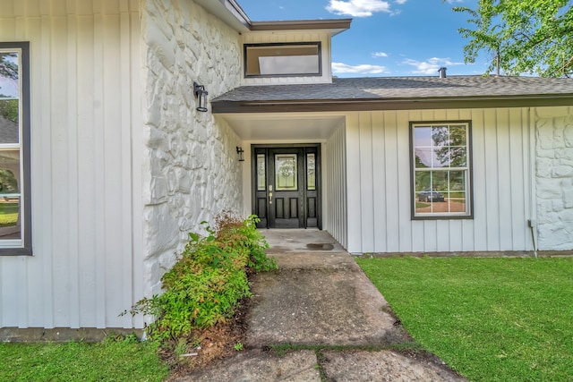 doorway to property featuring a yard