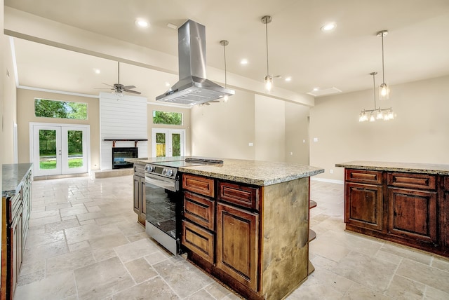 kitchen with a center island, hanging light fixtures, island range hood, electric stove, and ceiling fan