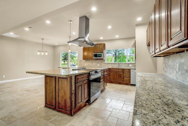 kitchen with appliances with stainless steel finishes, light tile floors, light stone counters, island exhaust hood, and tasteful backsplash