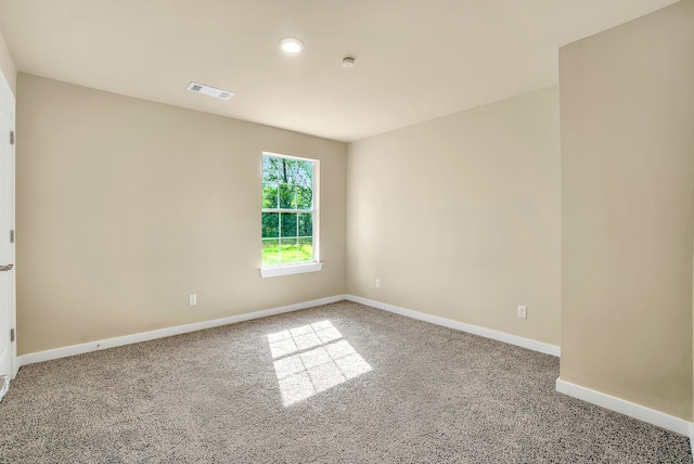 empty room featuring dark carpet