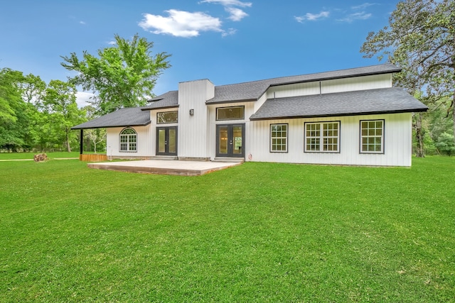 rear view of property featuring a patio area and a lawn