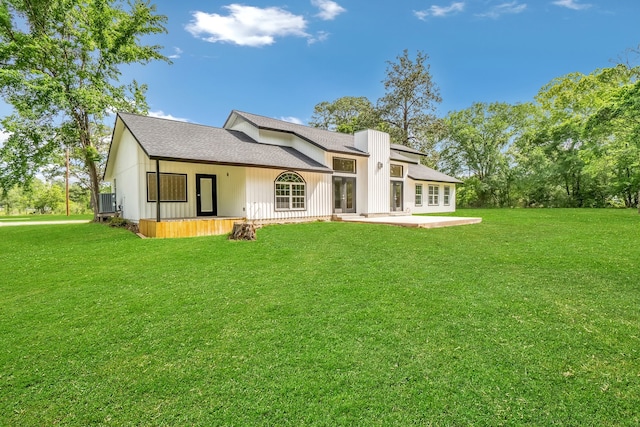 back of house featuring a patio area and a yard