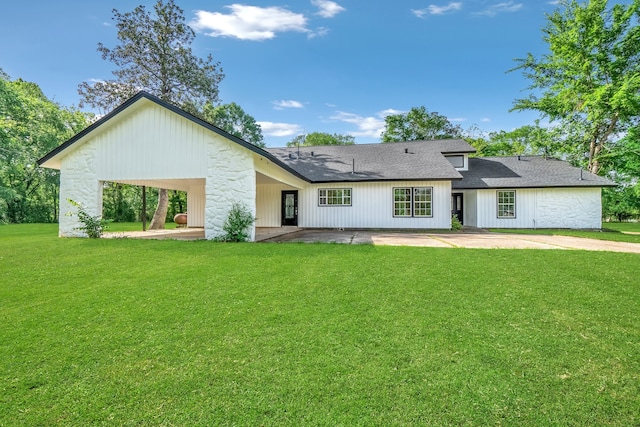 back of property featuring a patio and a lawn