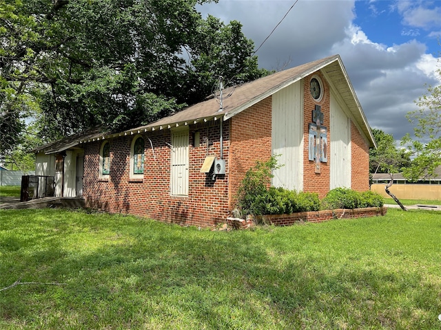 view of side of home featuring a yard