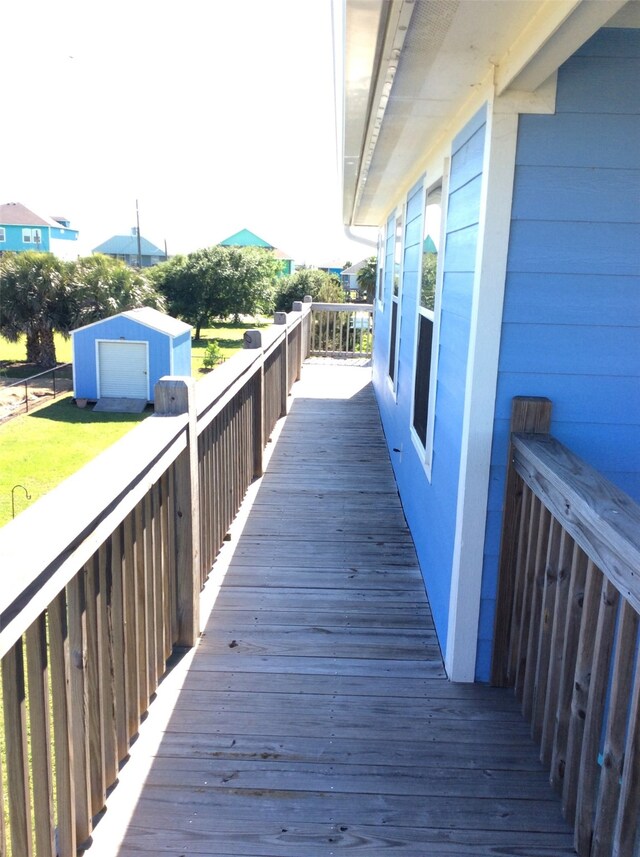 deck with a garage and an outbuilding