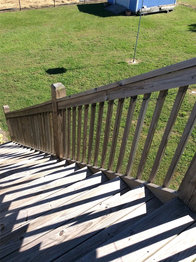 wooden deck featuring a yard