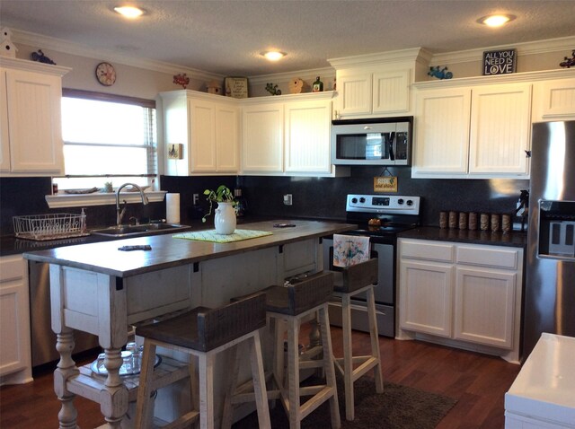 kitchen featuring white cabinets, dark hardwood / wood-style flooring, stainless steel appliances, and sink