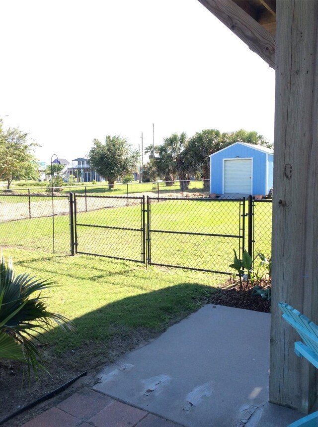 view of yard featuring an outbuilding, a garage, and a patio area