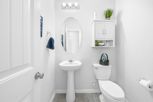 bathroom with toilet and tile flooring