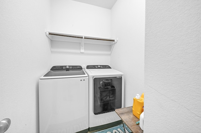 clothes washing area with washer and dryer