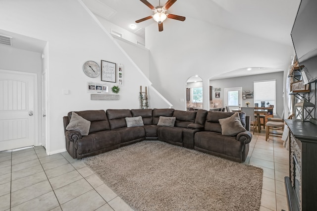 tiled living room with high vaulted ceiling and ceiling fan