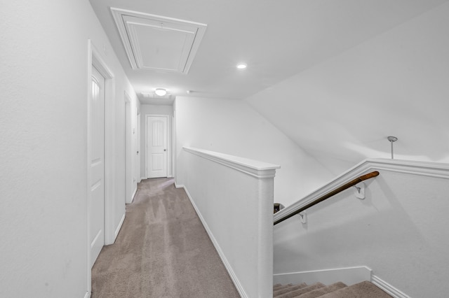 corridor featuring light carpet and lofted ceiling