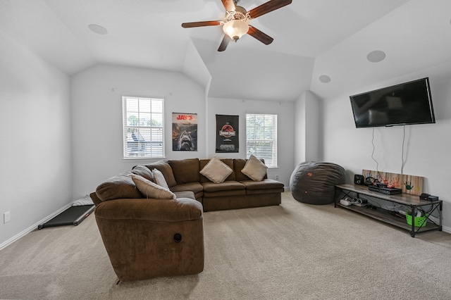 living room with a healthy amount of sunlight, lofted ceiling, ceiling fan, and light colored carpet