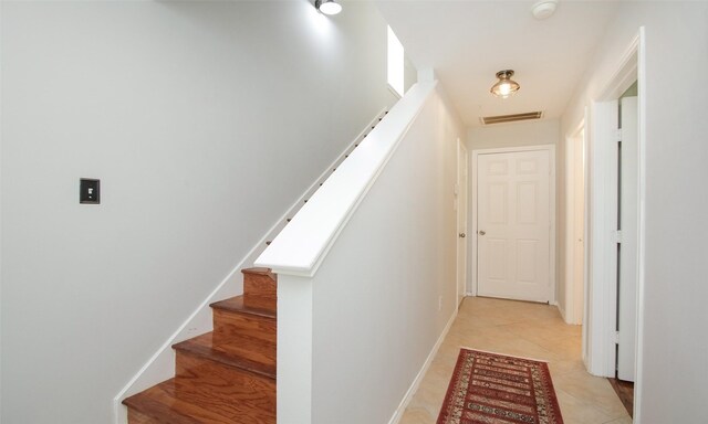 stairs with tile patterned floors