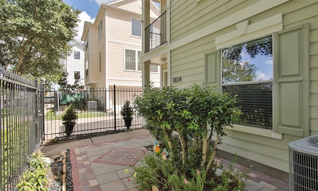 view of home's exterior with cooling unit and a patio