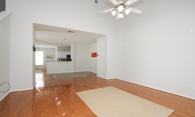 unfurnished living room with hardwood / wood-style flooring and ceiling fan