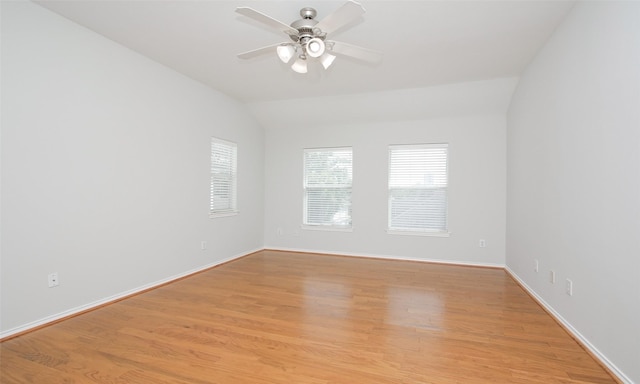 spare room featuring vaulted ceiling, light hardwood / wood-style floors, and ceiling fan