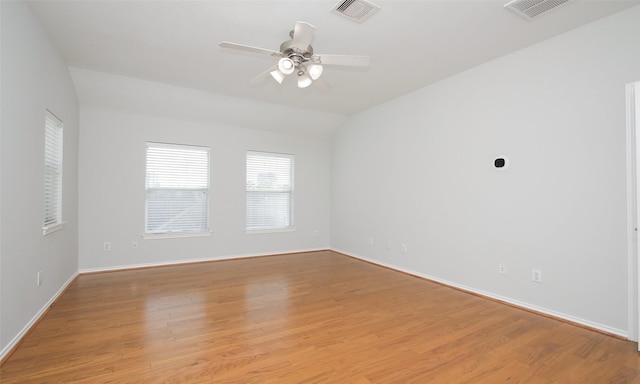 spare room with vaulted ceiling, ceiling fan, and light hardwood / wood-style floors