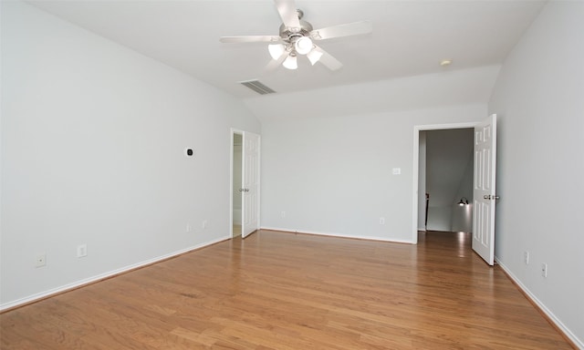 spare room featuring vaulted ceiling, ceiling fan, and light hardwood / wood-style floors