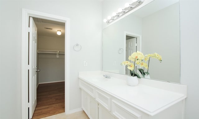 bathroom with vanity and hardwood / wood-style flooring