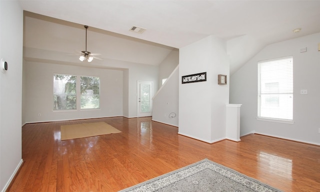 interior space featuring hardwood / wood-style flooring, vaulted ceiling, and a healthy amount of sunlight