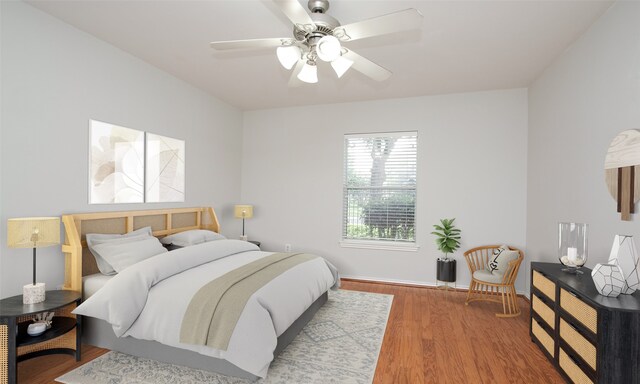 bedroom with ceiling fan and hardwood / wood-style floors