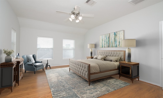 bedroom featuring lofted ceiling, ceiling fan, and light wood-type flooring