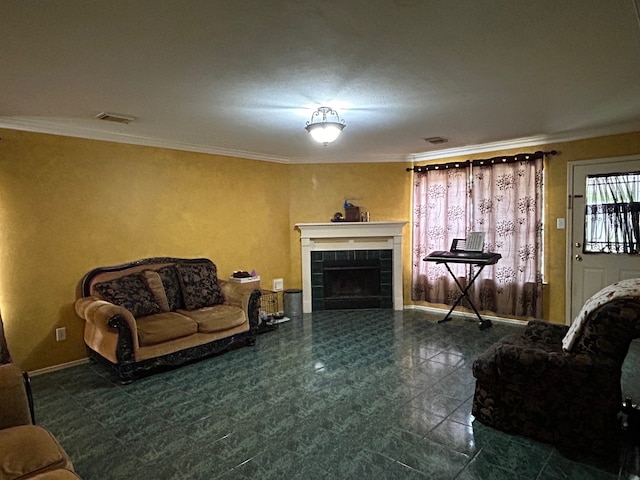 living room featuring dark tile flooring, crown molding, and a tiled fireplace