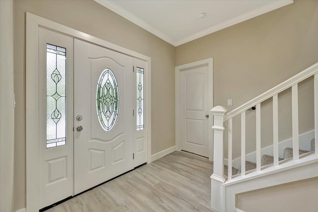 entryway with ornamental molding and light hardwood / wood-style flooring