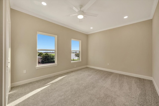 carpeted empty room with ornamental molding and ceiling fan