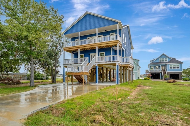 rear view of property with a yard, a carport, and covered porch