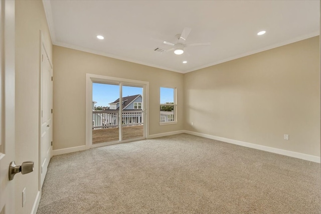 spare room featuring carpet, ceiling fan, and crown molding