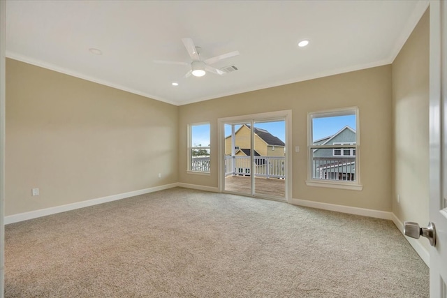 carpeted empty room featuring ornamental molding and ceiling fan