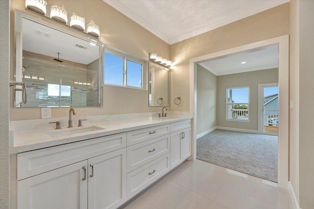 bathroom featuring a tile shower, vanity, ornamental molding, and tile patterned floors