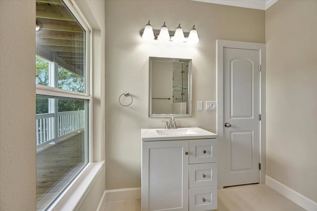 bathroom with ornamental molding, wood-type flooring, and vanity