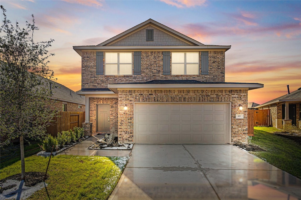 view of front property with a garage and a lawn