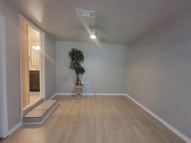 empty room with light hardwood / wood-style flooring