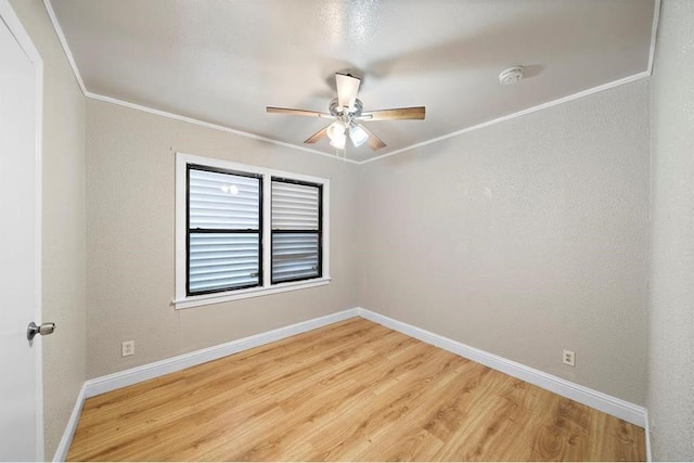 empty room featuring ceiling fan, hardwood / wood-style floors, and ornamental molding