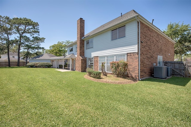 back of house featuring a patio, central AC, and a lawn